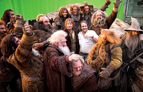 The Hobbit cast and Peter Jackson celebrate after completing a shot