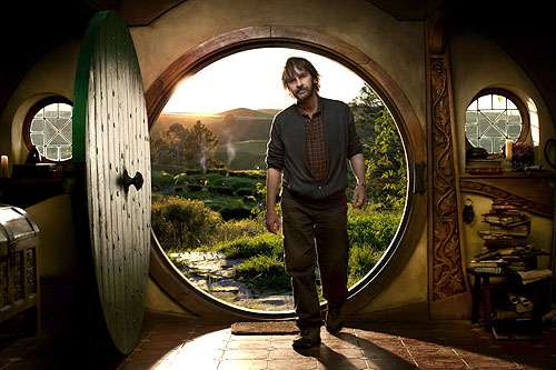 A publicity picture of Peter Jackson walking into Bag End in a blaze of sunshine
